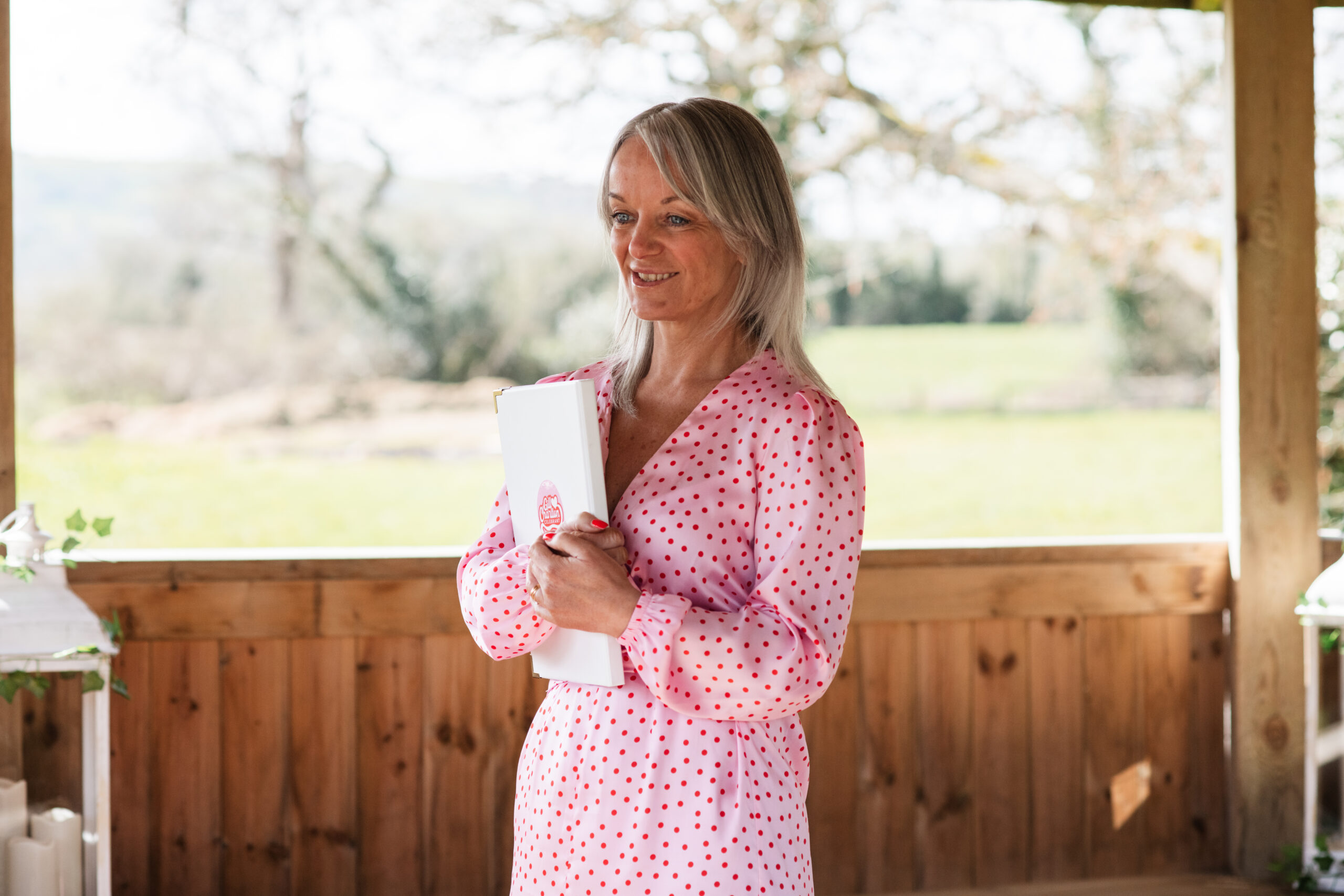 Gill, inclusive wedding celebrant in Lancashire and the North West, smiling after officiating an outdoor wedding at a pergola